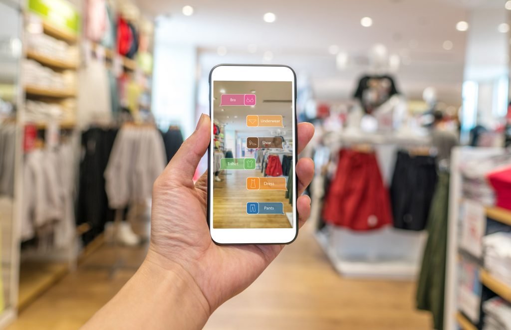 Augmented reality marketing . Hand holding smart phone use AR application to check information Augmented reality marketing . Hand holding smart phone use AR application to check information