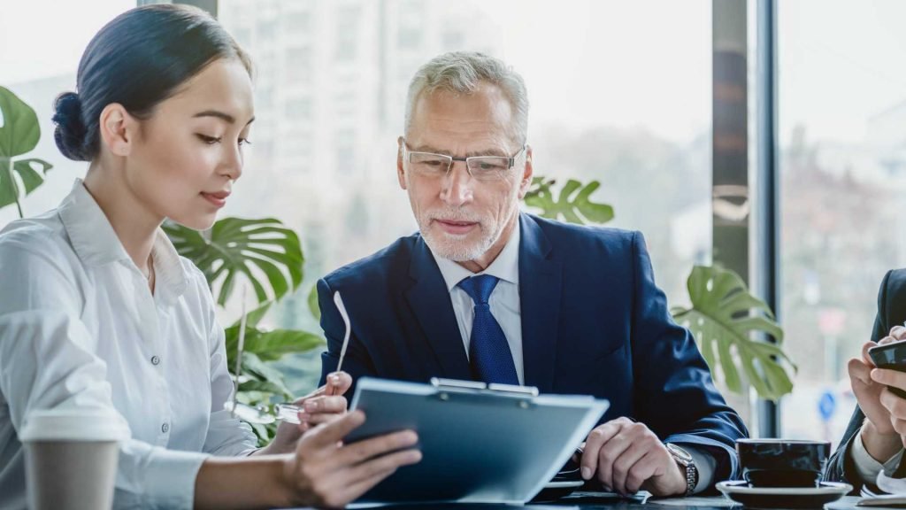 Business people working on business contract papers at office